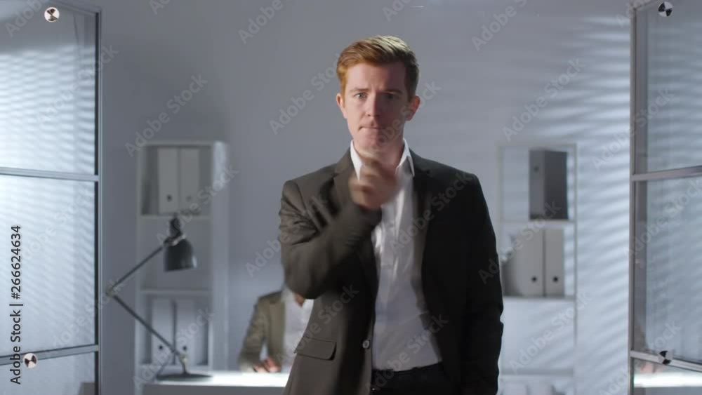 Poster young caucasian businessman in formal suit tapping and swiping on invisible augmented reality displa