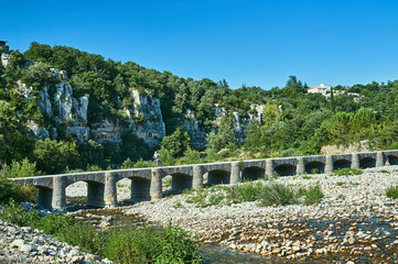 Fototapeta na wymiar Medieval stone bridge in the Ardeche ravine in France.
