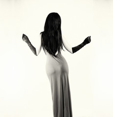 Beautiful young woman in sexy long gray dress.