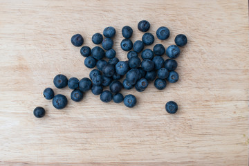 Blueberries on a wooden background. Blue berries, healthy food on dark table mockup, berry for smoothie on vintage rustic country board, copy space for text