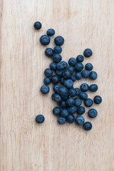 Blueberries on a wooden background. Blue berries, healthy food on dark table mockup, berry for smoothie on vintage rustic country board, copy space for text