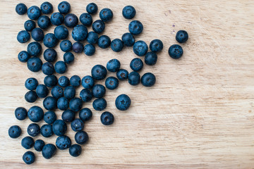 Blueberries on a wooden background. Blue berries, healthy food on dark table mockup, berry for smoothie on vintage rustic country board, copy space for text