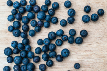 Blueberries on a wooden background. Blue berries, healthy food on dark table mockup, berry for smoothie on vintage rustic country board, copy space for text