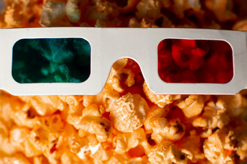 3d paper glasses and cheesy popcorn close up