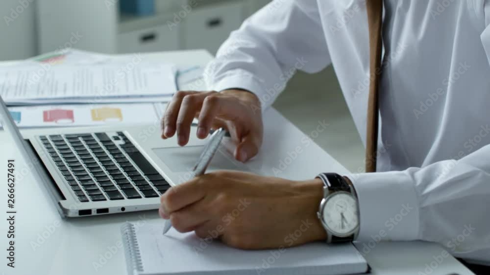 Poster mid-section shot of unrecognizable businessman in formal shirt and tie using touchpad on laptop and 