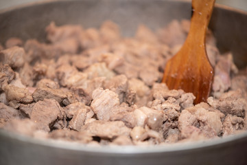 Home-made pork stew in pan, close up. Cooking process