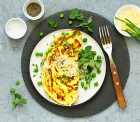 Breakfast. Frittata Italian omelet with green peas and salad.