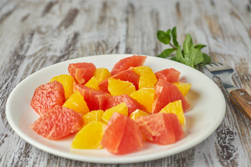 Orange-grapefruit citrus salad on a shabby wooden table close-up. summer vitamin salad. healthy food. dietary salad.