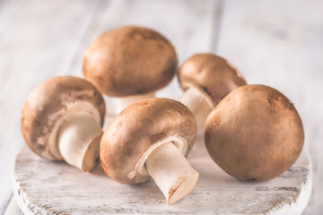 Champignon mushrooms on the wooden board