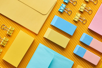 top view of colorful office stationery supplies on yellow
