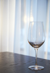 empty wine glass on the table in the restaurant on the background of the window in sunny weather. copy space.