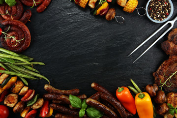 Assorted delicious grilled meat and skewer with vegetable on rustic table