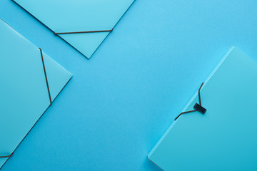 top view of paper binders isolated on blue with copy space