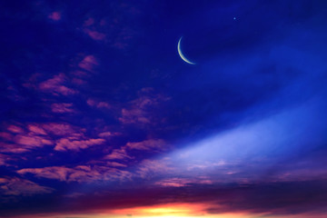 Obraz na płótnie Canvas Crescent moon with beautiful sunset background . Generous Ramadan . Light from sky . Religion background . 