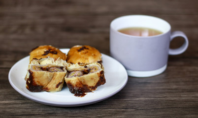 Banana chocolate pastry or bolen on wood background.  