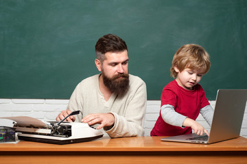 Teacher teaches a student to use a microscope. Happy family - daddy and son together. Man teaches...