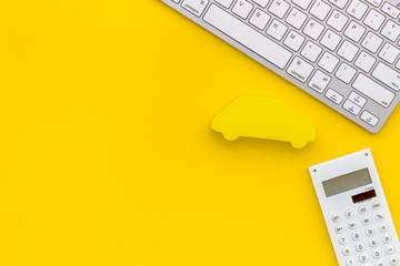 buying new auto concept with car toy, keyboard and calculator on yellow background top view copy...