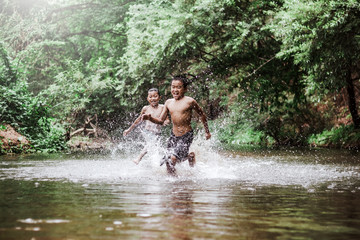 rural children playing water in the river