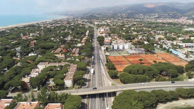 Barcelona. Aerial view from a drone on the highway and the road  in Castelldefels, coastal village in Spain. 4k Drone Video