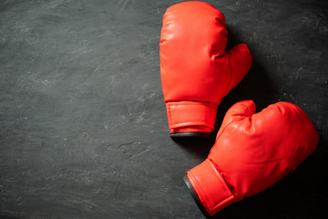 Boxing Gloves on black cement background. Concept of fighting or boxing. Top view and copy space...