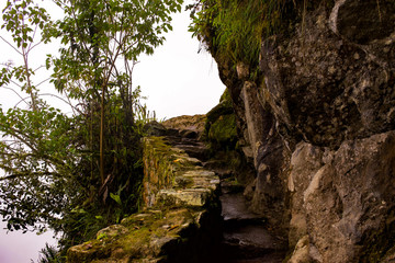 Rock stair curved Incan trail at Machu Picchu
