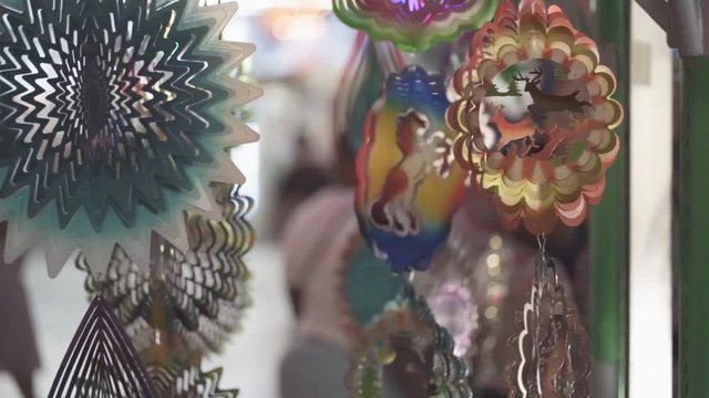 Static shot of some hand made colorful trinkets of animals, insects and objects along with a blurry background - bokeh.