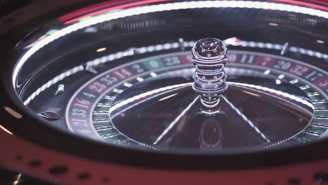 Static shot of a luxurious gambling roulette wheel while being played.