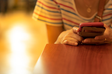 Women watching, playing something on the smartphone screen.