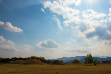 Fototapeta na wymiar Royal tombs and blue sky with clouds in Gyeongju, Korea.