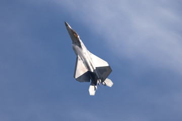 F-22 Raptor in beautiful light against clouds