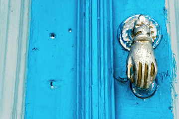 Blue Door with Bronze hand in Kairouan, Tunisia.