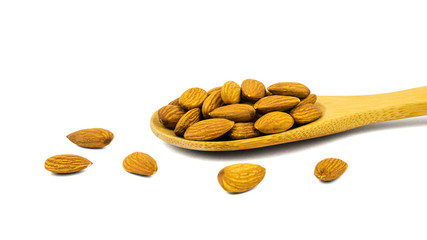 Wooden spoon and almonds izolirovannye on a white background.