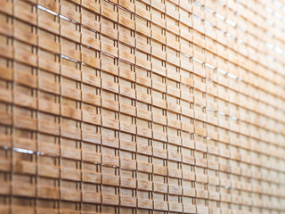 Closeup wooden blind textures with yellow sunlight in cafeteria.