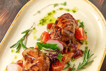 Grilled meat on pita bread on a bright oval plate. Dark wooden background. Restaurant menu