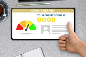 hand with tablet pc shows like, thumb up   on stone table background - good credit score technology concept