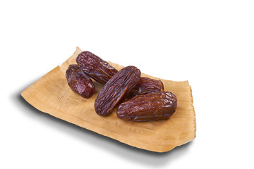 sweet dried dates fruit on dried banana leaf