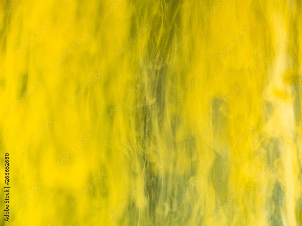 Poster abstract yellow background, close up view. blurred background. drops of yellow paint dissolving into