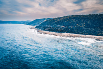 Forested hills over ocean coastline. Great Ocean Road, Victoria, Australia
