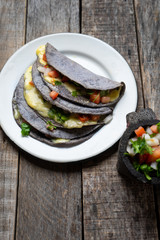Quesadillas with blue corn tortillas and mexican sauce