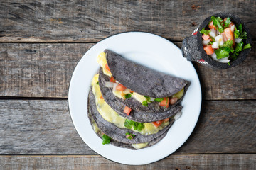 Quesadillas with blue corn tortillas and mexican sauce