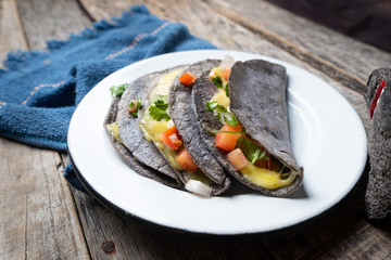 Quesadillas with blue corn tortillas and mexican sauce