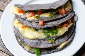 Quesadillas with blue corn tortillas and mexican sauce
