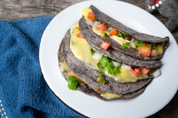 Quesadillas with blue corn tortillas and mexican sauce