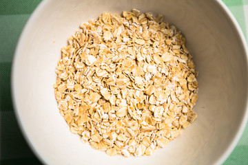 Healthy breakfast cereal oat flakes in bowl