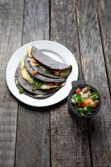 Quesadillas with blue corn tortillas and mexican sauce