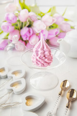 Delicate pink apple marshmallow, made by hand against the backdrop of beautiful tulips.