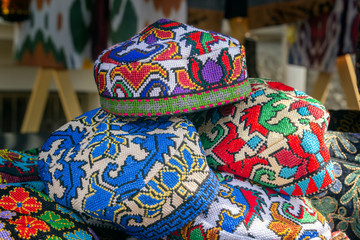 Traditional Asian headdresses with an embroidered colored thread of national ornament in a street...