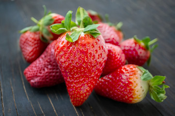Beautiful ripe strawberries for sale on a tray in wooden containers. without plastic