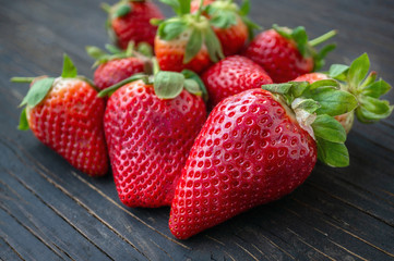 Beautiful ripe strawberries for sale on a tray in wooden containers. without plastic