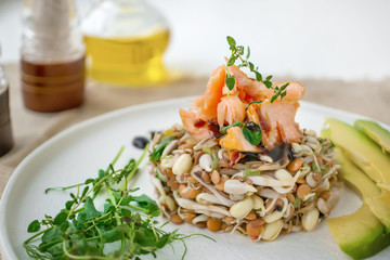 Salad of germinated seeds, trout and avocado. Macrobiotic food concept